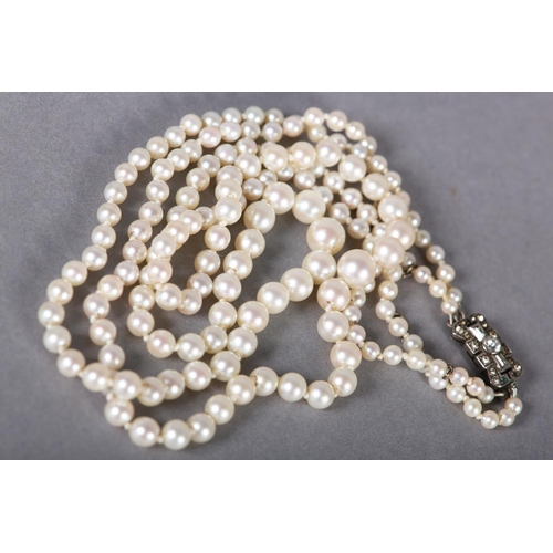 237 - A CULTURED PEARL TWO ROW NECKLACE, the graduated pearls fastened with a silver and colourless foil b... 