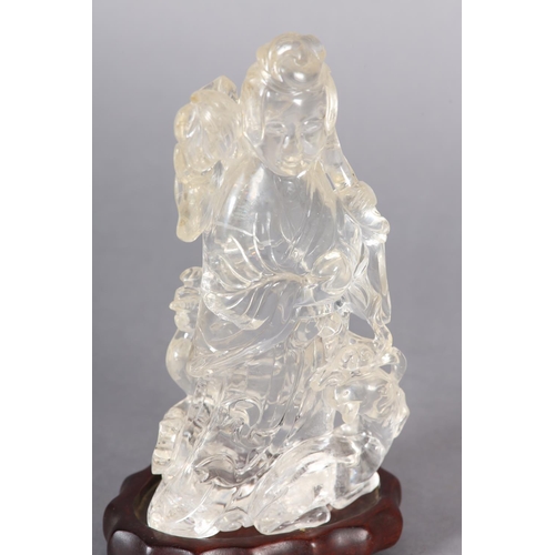 124 - A CHINESE ROCK CRYSTAL FIGURE OF THE IMMORTAL MAGU, holding a fruiting branch, a deer at her feet, 1... 