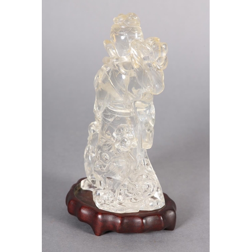 124 - A CHINESE ROCK CRYSTAL FIGURE OF THE IMMORTAL MAGU, holding a fruiting branch, a deer at her feet, 1... 