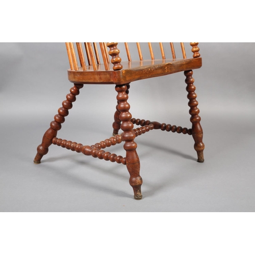 423 - A LATE VICTORIAN ELM AND FRUITWOOD HIGH RAIL BACK ARMCHAIR, broad seat, on bobbin turned legs and st... 