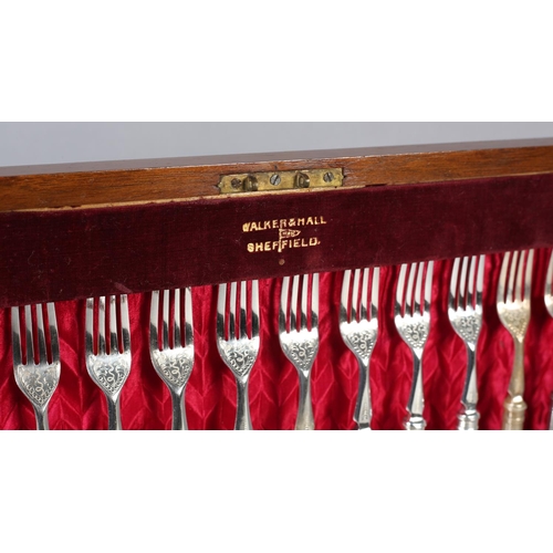 147 - AN EARLY 20TH CENTURY MAHOGANY CANTEEN OF TWELVE ENTRÉE KNIVES AND FORKS, by Walker & Hall, beaded h... 