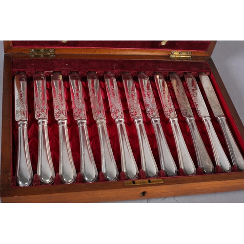 147 - AN EARLY 20TH CENTURY MAHOGANY CANTEEN OF TWELVE ENTRÉE KNIVES AND FORKS, by Walker & Hall, beaded h... 