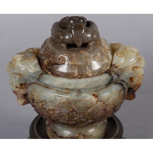 120 - A CHINESE CARVED HARDSTONE INCENSE BURNER AND COVER OF GREEN-BROWN COLOUR, having a domed and pierce... 