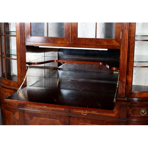 411 - A TITCHMARCH & GOODWIN MAHOGANY DISPLAY CABINET OF 'D' SHAPE having a moulded cornice above two trac... 