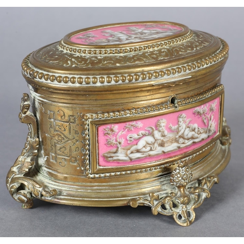 71 - A FRENCH TAHAN 19TH CENTURY ORMOLU AND ENAMEL CASKET of oval form, having enamel panels depicting ch... 