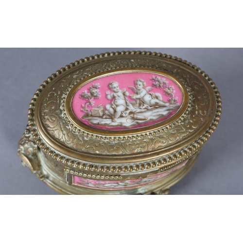 71 - A FRENCH TAHAN 19TH CENTURY ORMOLU AND ENAMEL CASKET of oval form, having enamel panels depicting ch... 