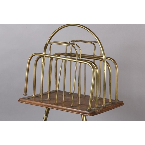 397 - AN EDWARDIAN BRASS AND MAHOGANY FOUR DIVISION REVOLVING MAGAZINE RACK with splayed legs on ball feet... 