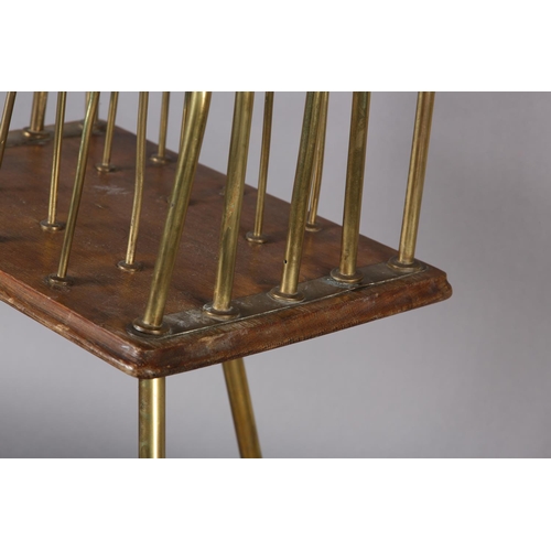 397 - AN EDWARDIAN BRASS AND MAHOGANY FOUR DIVISION REVOLVING MAGAZINE RACK with splayed legs on ball feet... 