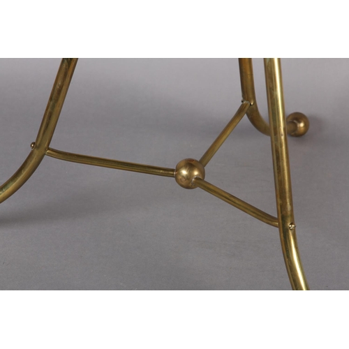 397 - AN EDWARDIAN BRASS AND MAHOGANY FOUR DIVISION REVOLVING MAGAZINE RACK with splayed legs on ball feet... 