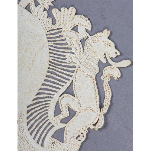 41 - AN 18TH CENTURY FRENCH ARMORIAL CREST CUT PAPER SAMPLE flanked by two lions above ornate pierced and... 