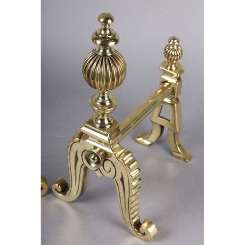 51 - A PAIR OF VICTORIAN BRASS FIREDOGS, each having a reeded ball and baluster upright, on frilled and s... 