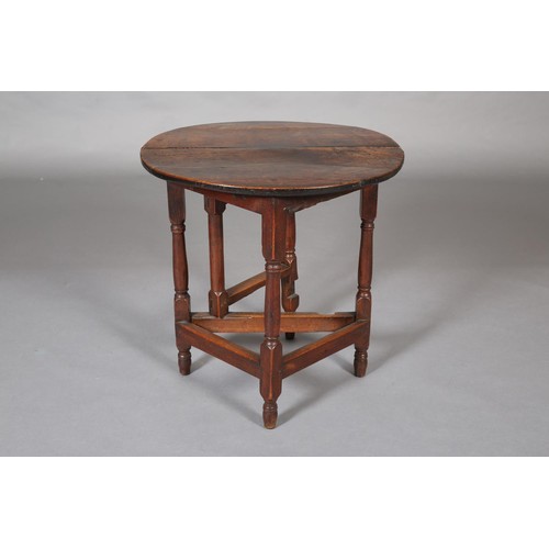 427 - A SMALL 18TH CENTURY OAK GATELEG TABLE, circular with single drop leaf, an turned and square framing... 