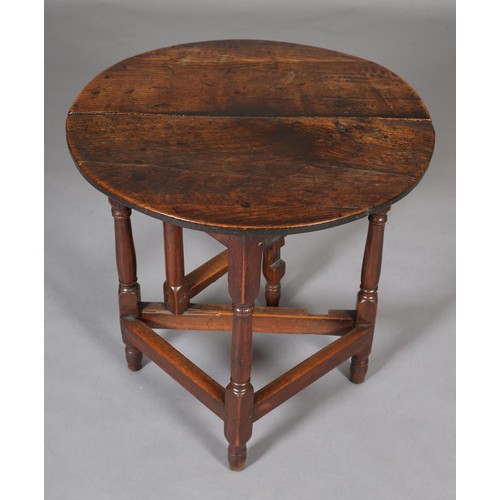 427 - A SMALL 18TH CENTURY OAK GATELEG TABLE, circular with single drop leaf, an turned and square framing... 