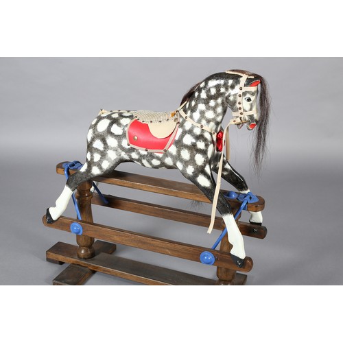 42 - A MID/LATE 20TH CENTURY ROCKING HORSE IN THE STYLE OF COLLINSON having black and white dappled body ... 