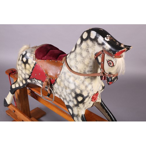 43 - A MID 20th CENTURY ROCKING HORSE IN THE STYLE OF COLLINSON having black and white dappled body with ... 