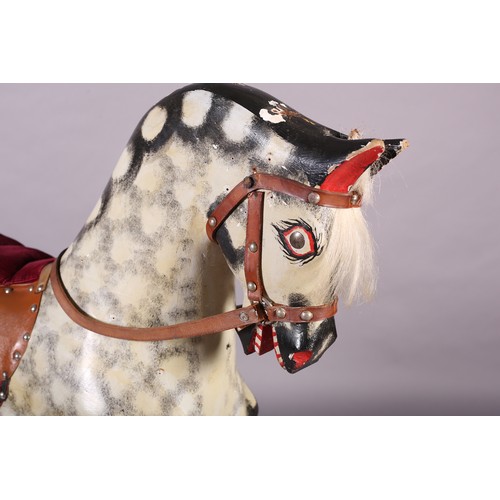 43 - A MID 20th CENTURY ROCKING HORSE IN THE STYLE OF COLLINSON having black and white dappled body with ... 