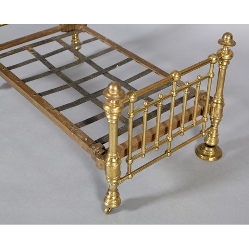 34 - A VICTORIAN DOLL'S BRASS AND IRON HALF-TESTER BED with wide brass knob finials (at fault), 73cm high... 