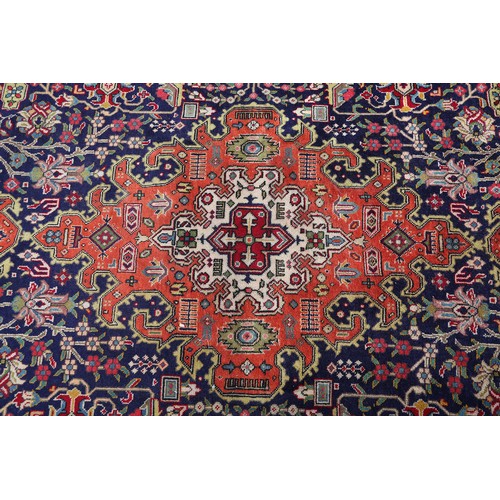 A MIDDLE EASTERN CARPET, Persian, the blue field filled with plant ...