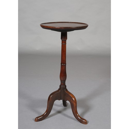 394 - A GEORGE III MAHOGANY TRIPOD TABLE having a circular dished top on a slender ring turned column and ... 