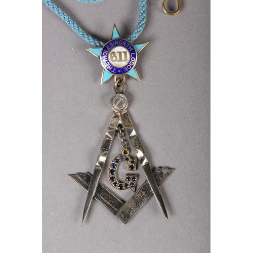 167 - A MASONIC MASTERS JEWEL in sapphire set silver, the square and compass with pendant stone set G belo... 