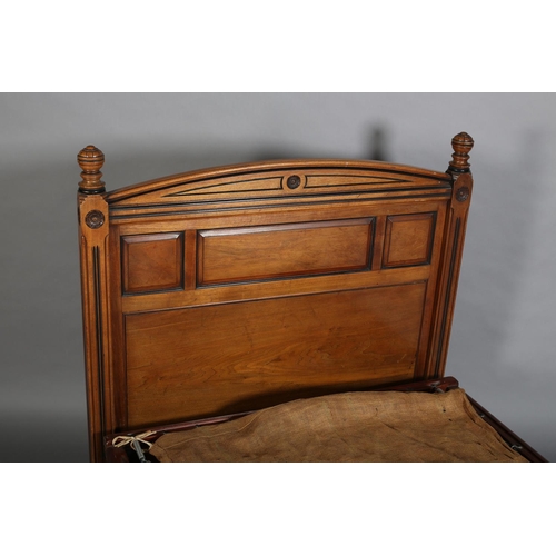 377 - AN EDWARD VII WALNUT SINGLE BEDSTEAD, with ebonised detailing, the curved profile headboard triple f... 