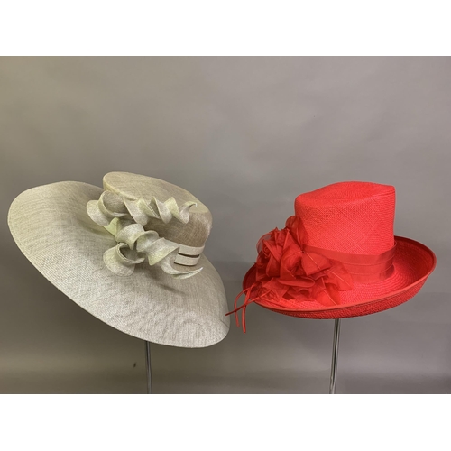 247 - Cosmo Jenks asymmetrical red straw hat with organza rose detail to the grosgrain ribbon, contained i... 