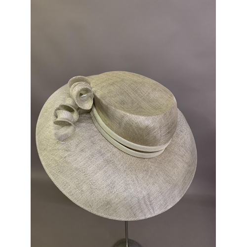 247 - Cosmo Jenks asymmetrical red straw hat with organza rose detail to the grosgrain ribbon, contained i... 