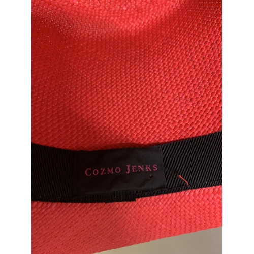247 - Cosmo Jenks asymmetrical red straw hat with organza rose detail to the grosgrain ribbon, contained i... 