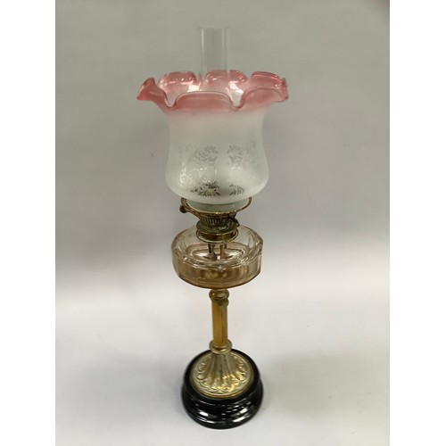 204 - A Victorian oil lamp with glass reservoir and reeded support on black stepped base, having an opaque... 