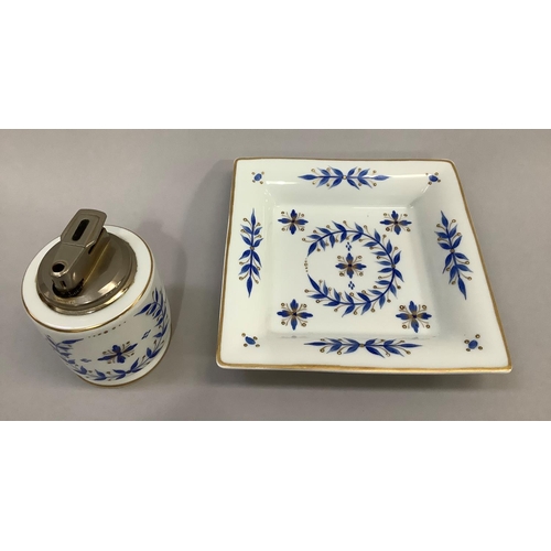 12 - An Asprey Limoges table lighter and tray, painted with blue foliage and gilt mark to base, lighter 9... 