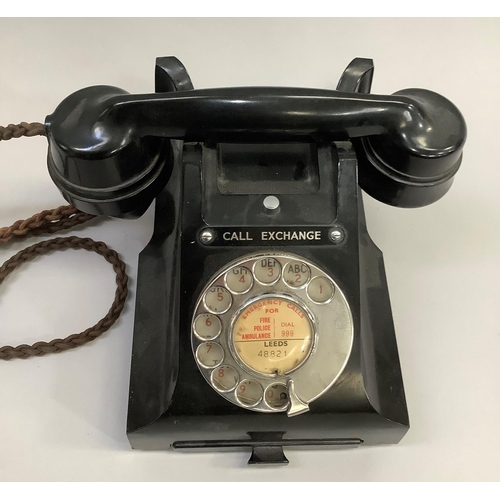 13 - A black GPO bakelite desk telephone with directory tray