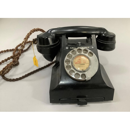 13 - A black GPO bakelite desk telephone with directory tray