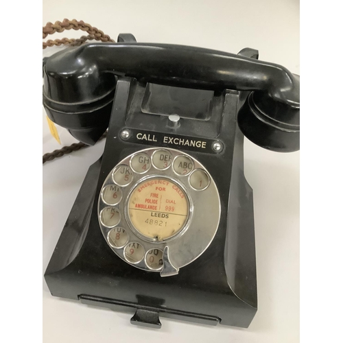 13 - A black GPO bakelite desk telephone with directory tray