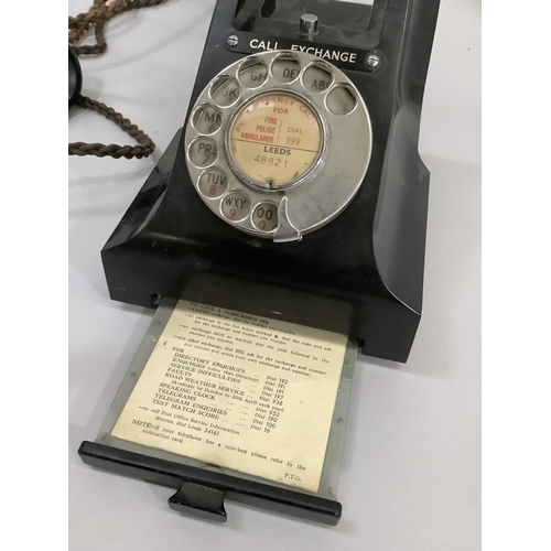 13 - A black GPO bakelite desk telephone with directory tray