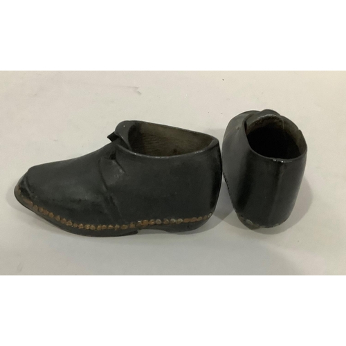 23 - A pair of early 20th century children's clogs with a buckle, marked 1900 to base