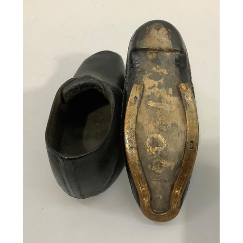 23 - A pair of early 20th century children's clogs with a buckle, marked 1900 to base