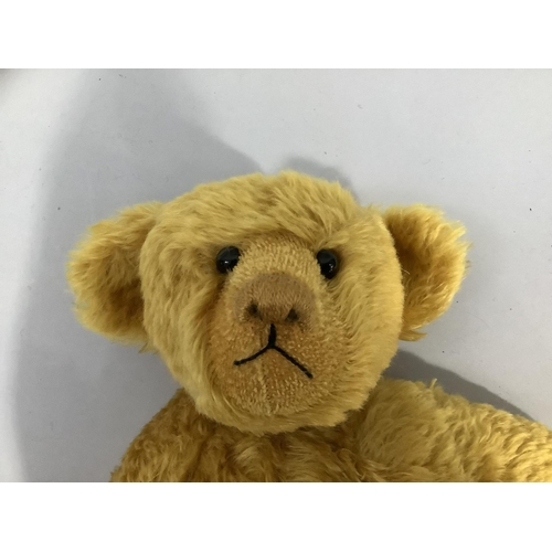 27 - A golden plush bear with hump back and centre seam, boot button eyes, stitched snout, jointed body a... 