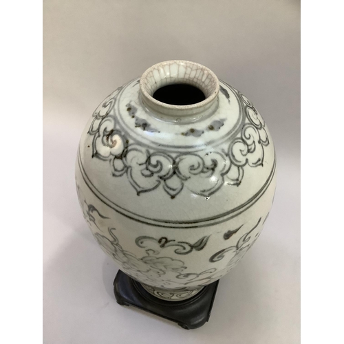 194 - A Japanese crackle glaze vase of ovoid form painted in monochrome pallet with fruited vine within la... 