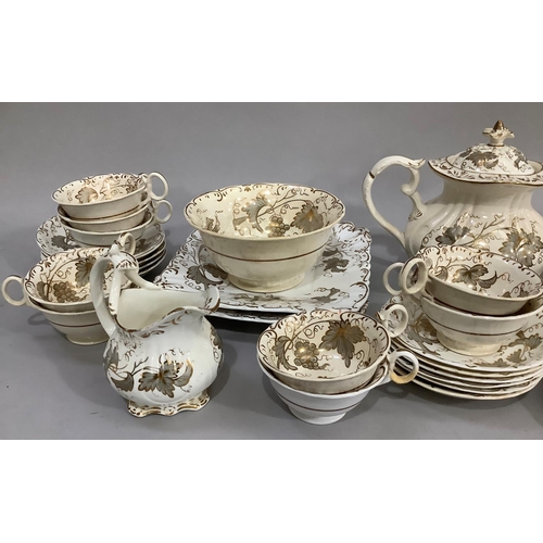 139 - A mid 19th century Rockingham style tea service comprising twelve cups, eleven saucers, milk jug, sl... 