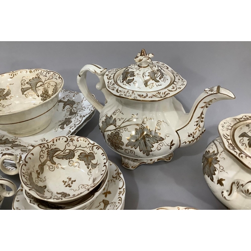 139 - A mid 19th century Rockingham style tea service comprising twelve cups, eleven saucers, milk jug, sl... 