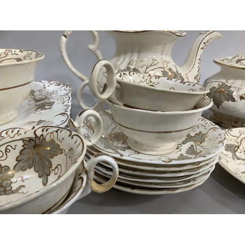 139 - A mid 19th century Rockingham style tea service comprising twelve cups, eleven saucers, milk jug, sl... 