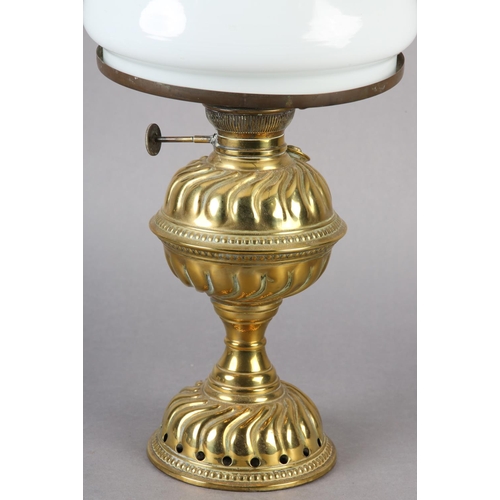 207 - A Victorian brass oil lamp, having a wrythen embossed 'cup and cover' reservoir and conforming domed... 