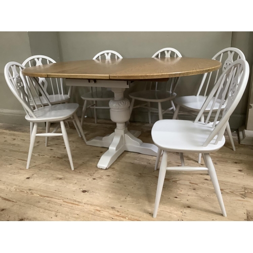 58 - A painted and oak topped dining table with baluster supports and pull out folding leaf together with... 