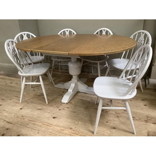 58 - A painted and oak topped dining table with baluster supports and pull out folding leaf together with... 