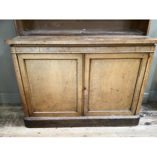 60 - An oak Victorian and later bookcase four shelves above two doors with two internal drawers with sunk... 