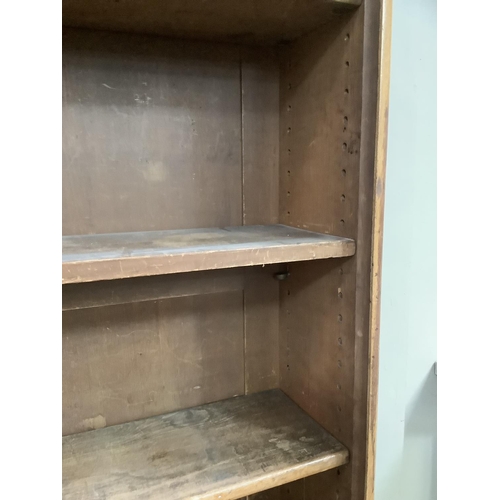 60 - An oak Victorian and later bookcase four shelves above two doors with two internal drawers with sunk... 