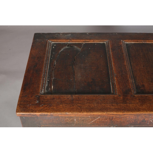 66 - An Early 18th century oak kist having a triple indented top above a frieze carved with the initials ... 