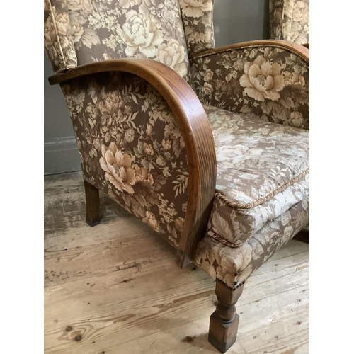 68 - A pair of 20th century oak wing back arm chairs with bentwood arms, upholstered in floral fabric