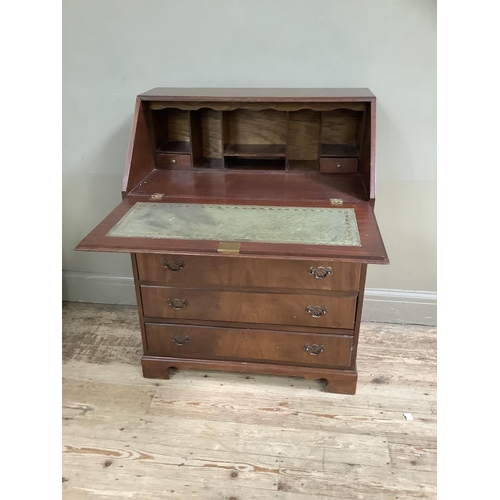 70 - A reproduction mahogany veneered bureau with drop down compartment the lid inlaid with leather inset... 