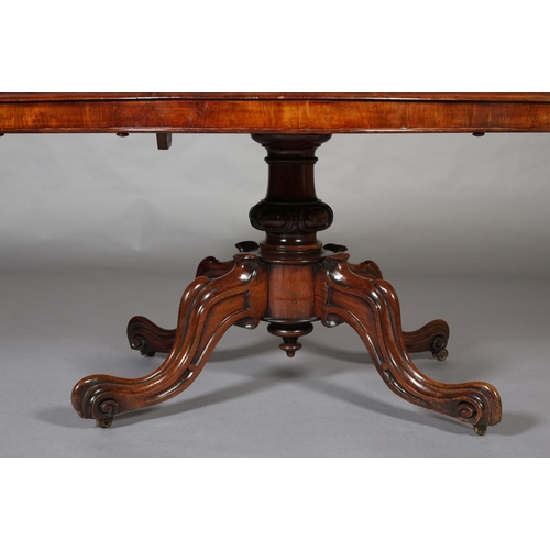 73 - A Victorian Looe table, having an oval tilt top, on short lobed column and quadruple base with hippe... 